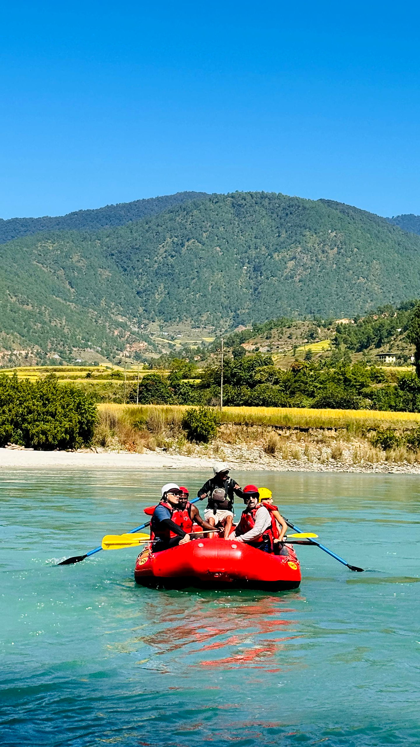 A raft team paddling together down the Punakha river
