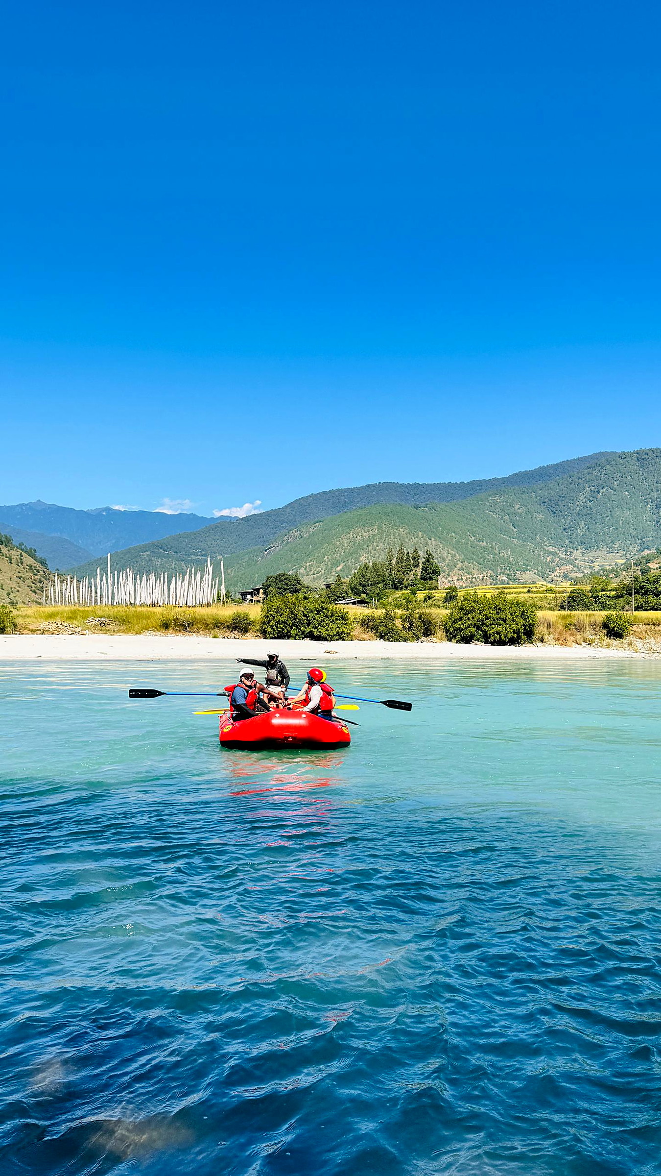 Spray flying as a raft drops into a rapid in Punakha