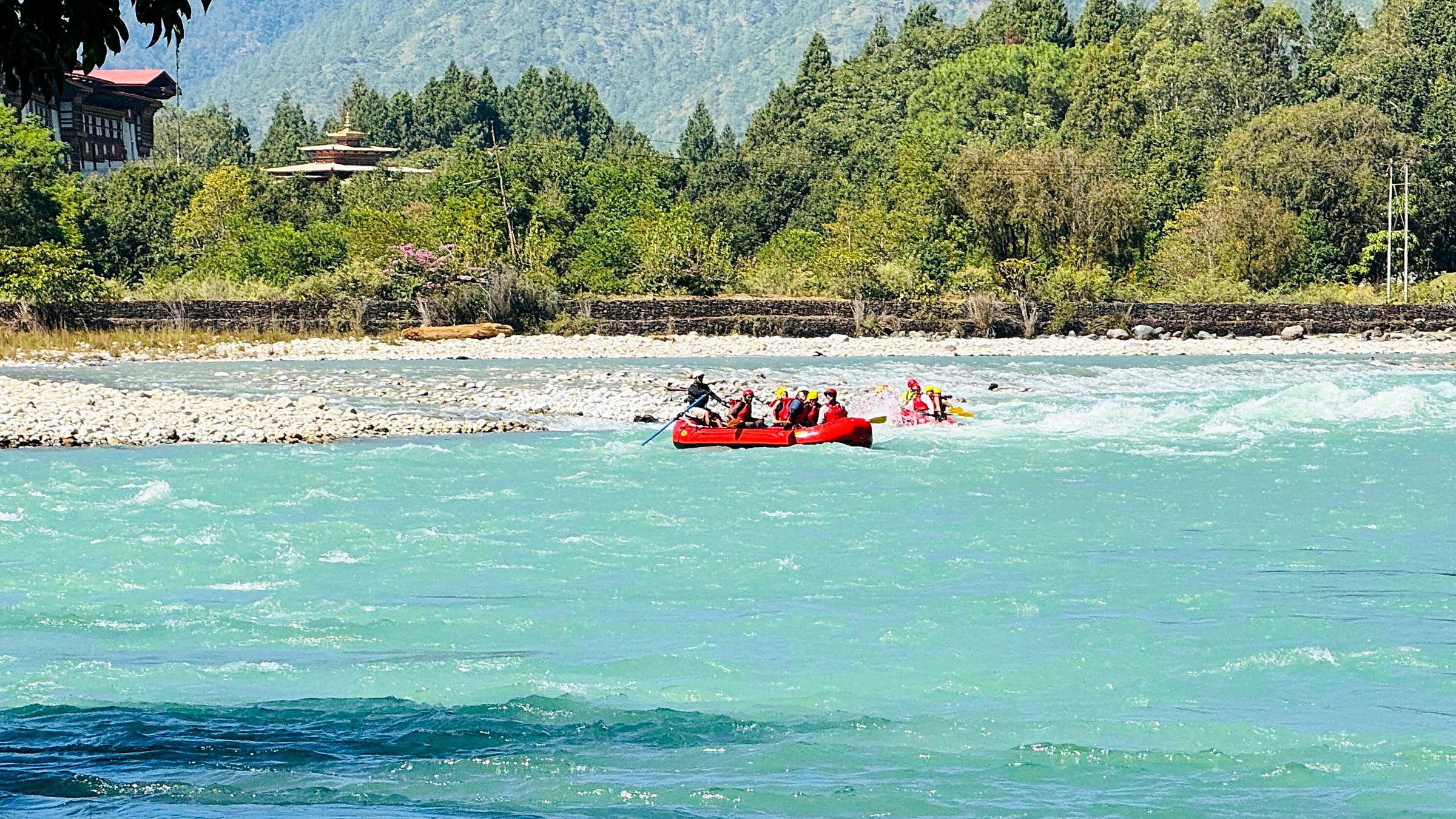 The Punakha river winding between forested hills