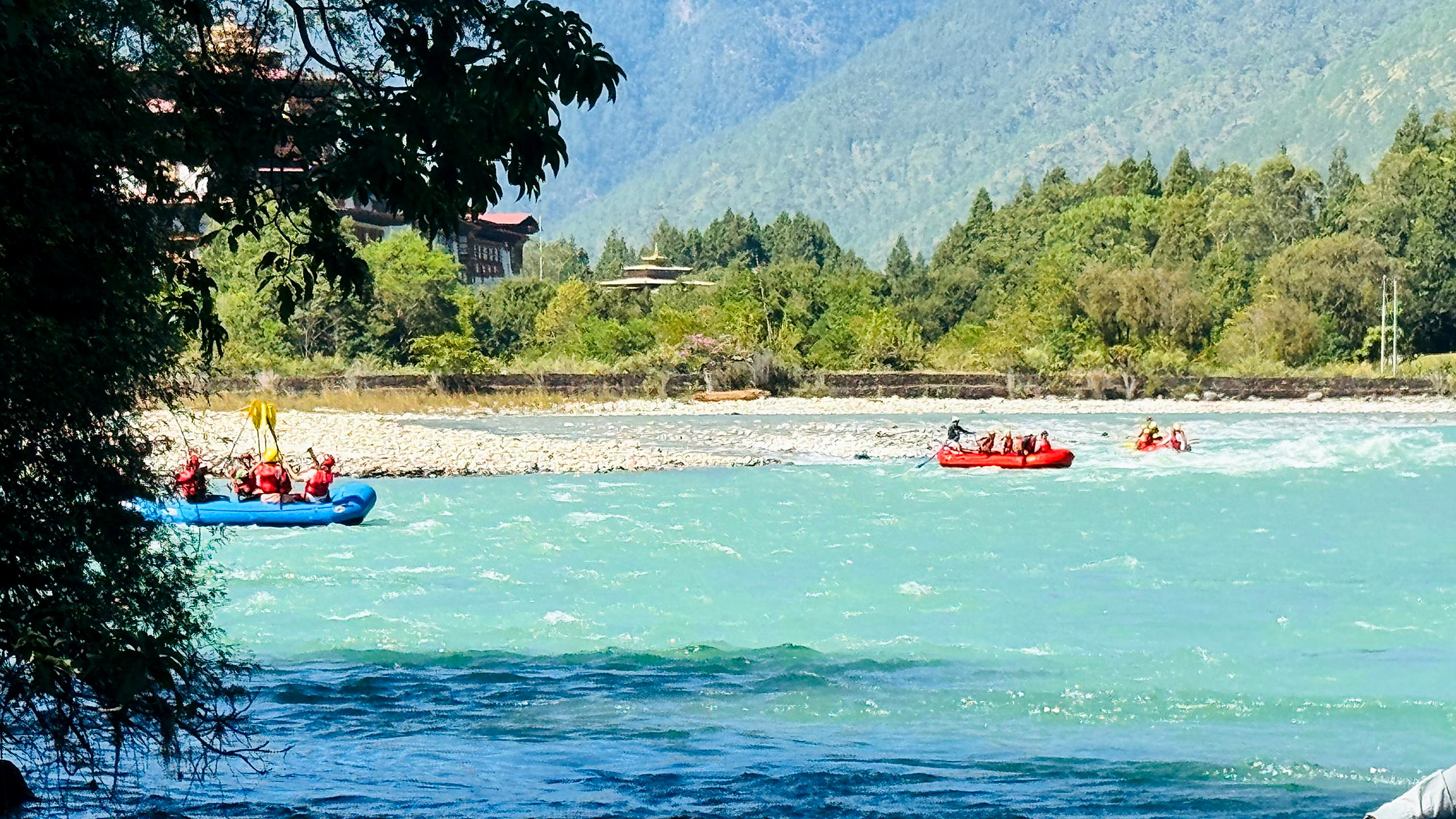 Wide view of the Punakha river with rafts on the water